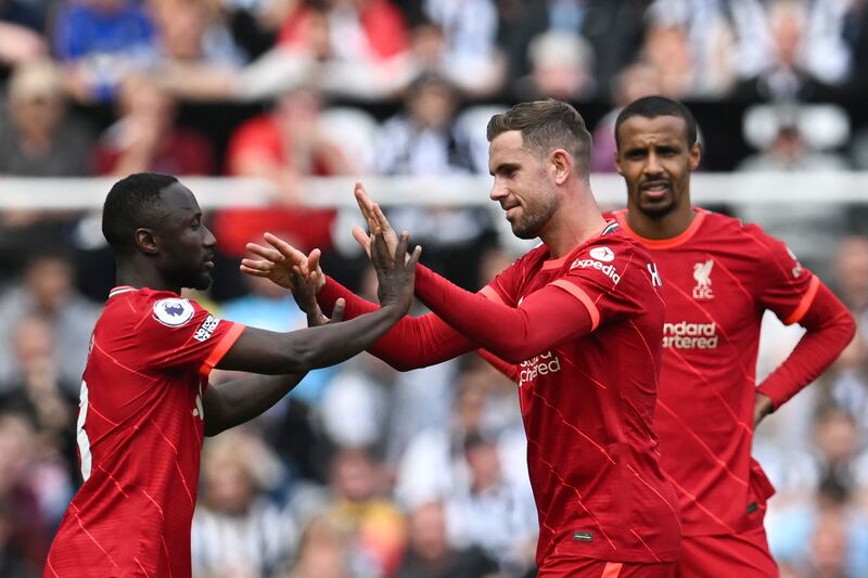 Jordan Henderson is congratulated by Naby Keita as he leaves the pitch. AFP