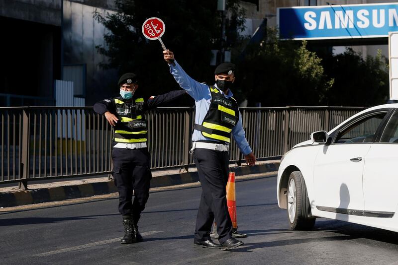 Jordanian police personnel guard at a checkpoint during the second day of a nationwide curfew, imposed for two days, amid fears of a rising number of coronavirus disease (COVID-19) cases in downtown Amman, Jordan. REUTERS