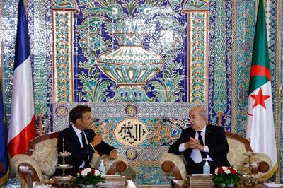 French President Emmanuel Macron talks with Algeria's President Abdelmadjid Tebboune at the VIP lounge of the airport in Algiers at the start of his official visit to Algeria. AFP