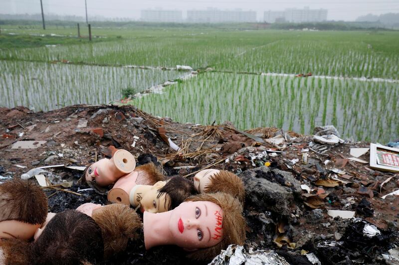 Heads of mannequins are seen by the roadside near an apartment and office project in Hanoi, Vietnam. Reuters