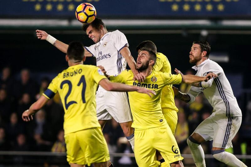 Real Madrid defender Pepe, secondleft, vies with Villareal defender Victor Ruiz. Biel Alino / AFP