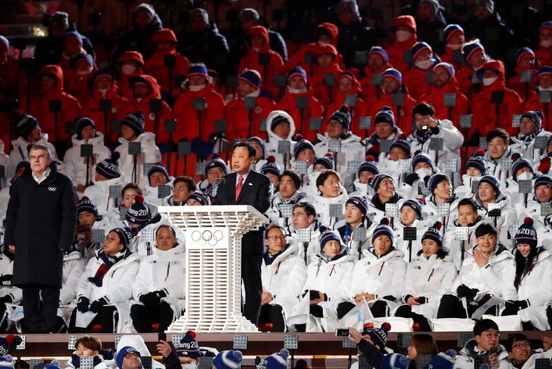 Lee Hee-beom, president and chief executive of the Pyeongchang Organising Committee speaks as International Olympic Committee President Thomas Bach stands to his right during the opening ceremony of the 2018 Winter Olympics. Petr David Josek / AP Photo
