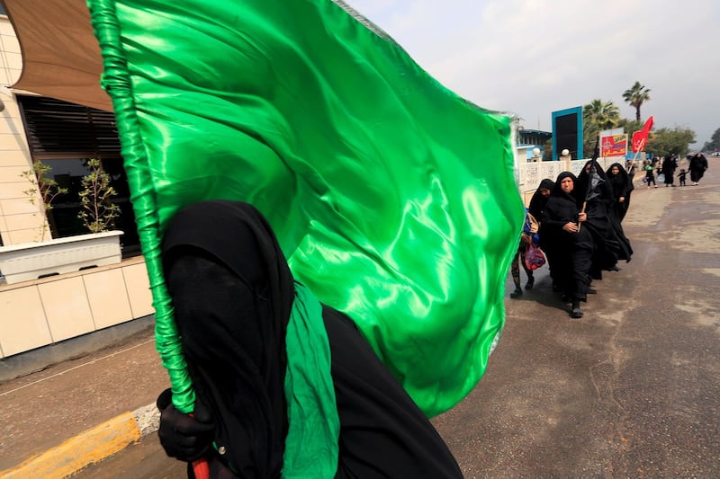 Shi'ite pilgrims make their way to Kadhimiya during a curfew. Reuters