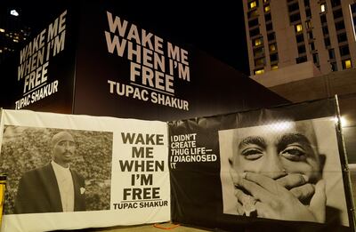 Portraits and quotes from Shakur outside LA's Tupac Shakur: Wake Me When I'm Free exhibition last year. AP