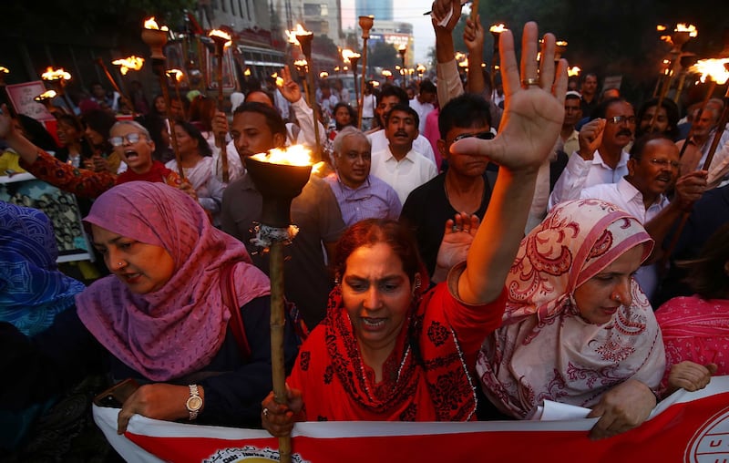 Activists of the Pakistan Food Workers Federation hold torches and banners and chant slogans as they join a rally on the eve of World Labor Day in Karachi, Pakistan, 30 April 2023.  Labor Day is an annual holiday that takes place on 01 May and celebrates laborers, their rights, achievements, and contributions to society.   EPA / SHAHZAIB AKBER