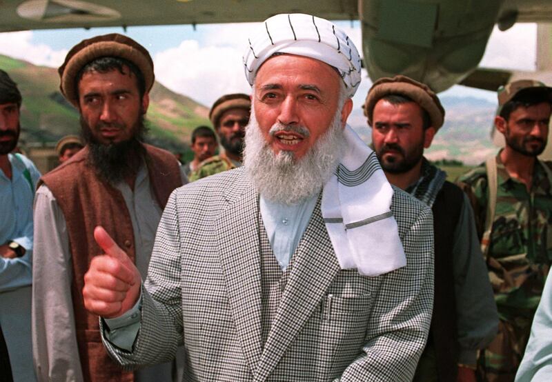 (FILES) This June 4, 1998 file photograph shows former Afghan President Burhanuddin Rabbani (C) speaking to journalists at Faizabad airstrip. On September 20, 2011 Burhanuddin Rabbani, Afghanistan's former president tasked with finding a peace deal with the Taliban was assassinated in a suicide attack at his Kabul home, according to police. AFP PHOTO
 *** Local Caption ***  872432-01-08.jpg