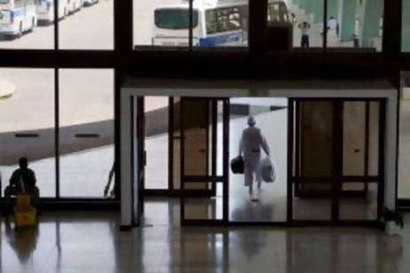 ABU DHABI, UNITED ARAB EMIRATES - April 1, 2008: A man exits the Abu Dhabi Municipality Main Bus Terminal. (Philip Cheung / The National )