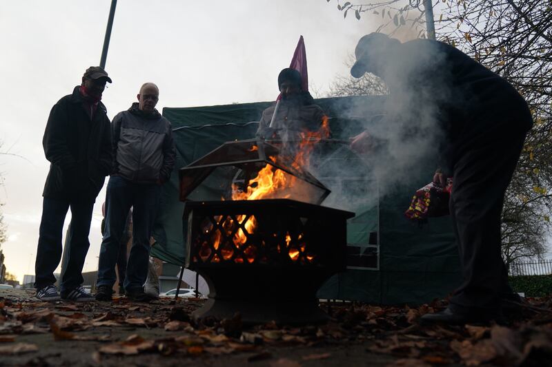 Postal workers light a fire outside the Central Delivery Office and Mail Centre in Birmingham. PA