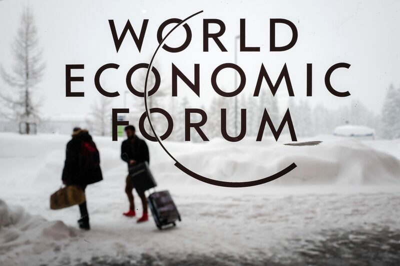 Two people leave the Congress Centre under snow ahead of the opening of the World Economic Forum (WEF) 2018 annual meeting, on January 22, 2018 in Davos, eastern Switzerland.
US President Donald Trump's participation at the World Economic Forum in Davos, Switzerland next week could be thrown into question now that the federal government has partially shut down over budget wrangling, the White House said on January 20. / AFP PHOTO / Fabrice COFFRINI