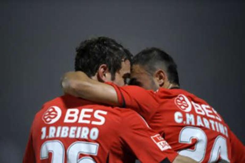 Benfica's Jorge Ribeiro, left, celebrates with his teammate Carlos Martins after scoring the fourth goal against Pacos Ferreira.