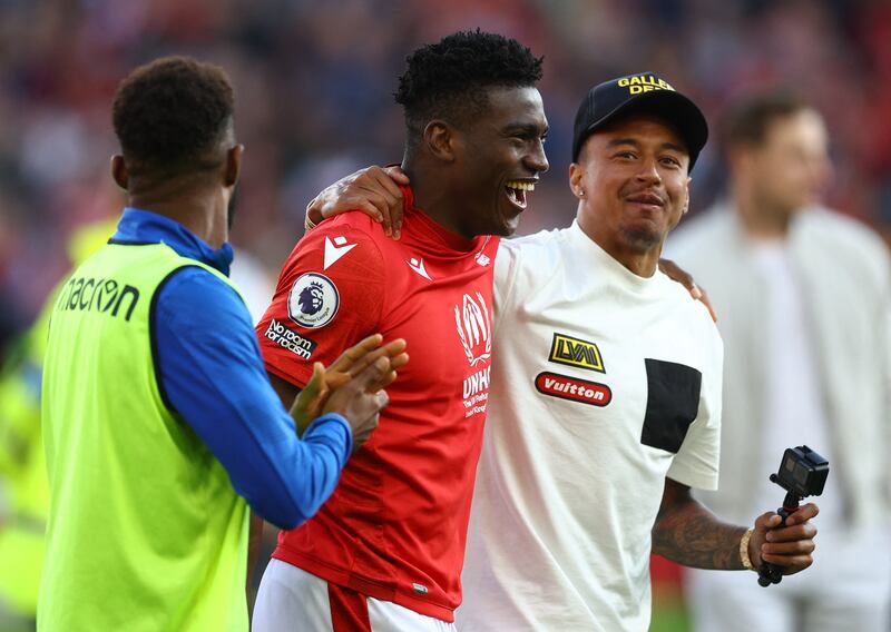 Nottingham Forest's Taiwo Awoniyi and Jesse Lingard celebrate avoiding relegation. Reuters