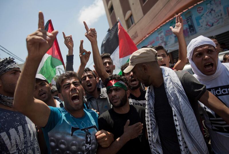 Palestinian mourners chant angry slogans during the funeral of a volunteer paramedic Razan Najjar, 21, in Khan Younis, Ssouthern Gaza Strip, Saturday, June 2, 2018. Najjar was killed by Israeli fire Friday during mass protests in the Gaza Strip, the Palestinian Health Ministry said. (AP Photo/Khalil Hamra)