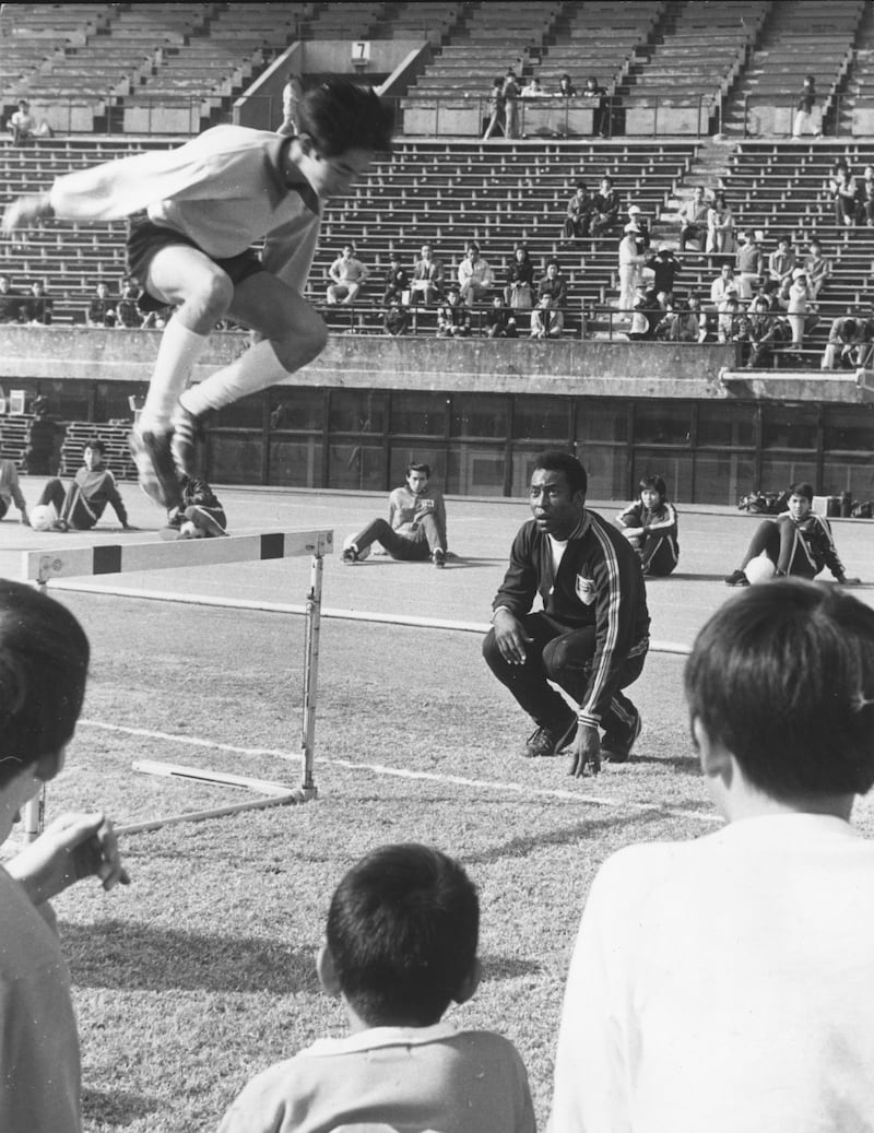 A retired Pele coaches Japanese boys at the National Stadium in Tokyo, in November 1974. Getty Images