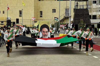 Hezbollah's Imam Al Mahdi Scouts carry a Palestinian flag and a picture depicting Iran's founder Ayatollah Ruhollah Khomeini as they march to commemorate Al Quds Day (Jerusalem Day) in a suburb of Beirut, Lebanon, this week. EPA
