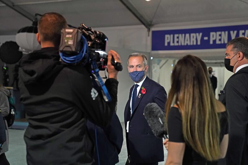 Mark Carney, the former Bank of England governor, speaks to a TV crew at the summit. PA