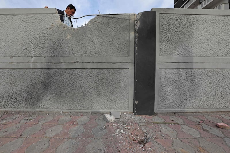 A man inspects the damage near the scene of a rocket attack in Erbil, the capital of the northern Iraqi Kurdish autonomous region. AFP