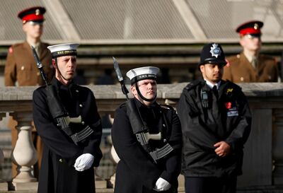 Members of the Royal Navy stand with a Police officer, and members of the Army, ahead of the Remembrance Sunday ceremony at the Cenotaph on Whitehall in central London, on November 8, 2020. Remembrance Sunday is an annual commemoration held on the closest Sunday to Armistice Day, November 11, the anniversary of the end of the First World War and services across Commonwealth countries remember servicemen and women who have fallen in the line of duty since WWI. This year, the service has been closed to members of the public due to the novel coronavirus COVID-19 pandemic. / AFP / POOL / PETER NICHOLLS
