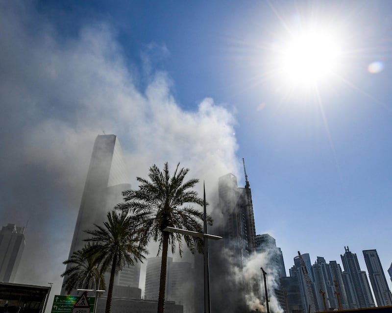 Smoke rises from a fire in a tower in the Business Bay area of Dubai. Karim Sahib / AFP
