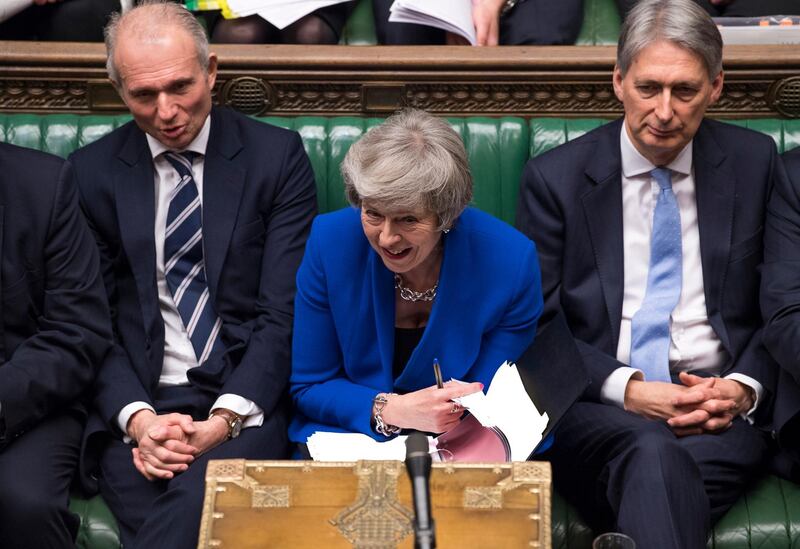 Prime Minister Theresa May reacts during a debate before a no-confidence vote raised by opposition Labour Party leader Jeremy Corbyn, in the House of Commons. AP