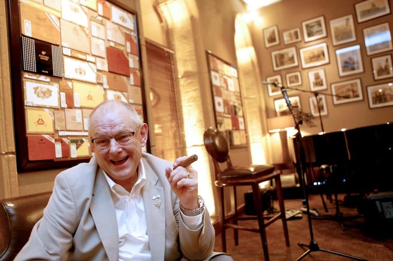 Dr Steven Hughes enjoys a cigar at the Havana Club at the Emirates Palaces in Abu  Dhabi. Sammy Dallal / The National