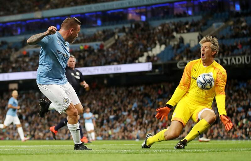 Manchester City Legends' Craig Bellamy in action with Premier League All-Stars' Edwin Van De Sar. Reuters