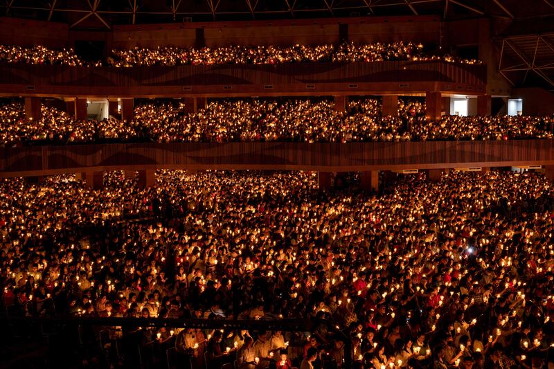 Christians hold candles during a midnight mass on Christmas Eve at the Bethany Church in Surabaya in December. AFP