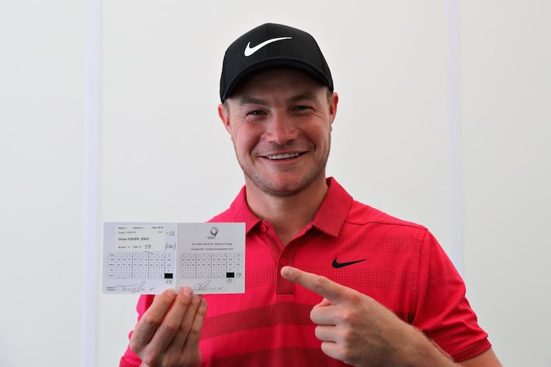 ALBUFEIRA, PORTUGAL - SEPTEMBER 21:  Oliver Fisher of England celebrates with his scorecard after finishing with a round of 59, the first 59 scored on the European Tour during Day Two of the Portugal Masters at Dom Pedro Victoria Golf Course on September 21, 2018 in Albufeira, Portugal.  (Photo by Warren Little/Getty Images)