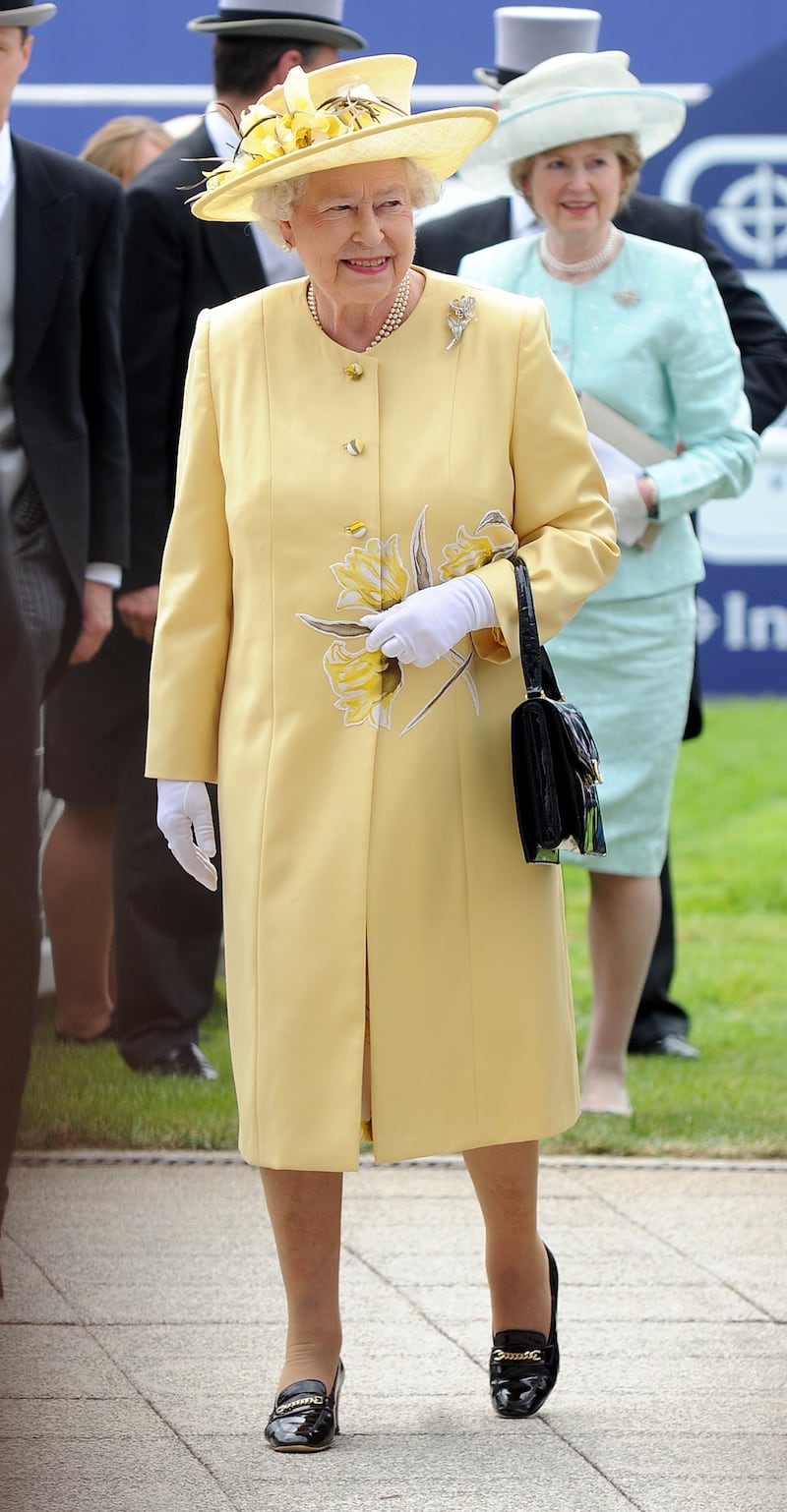 Queen Elizabeth II, wearing yellow, attends Derby Day of the Epsom Derby on June 5, 2010, in Epsom, England. Getty Images