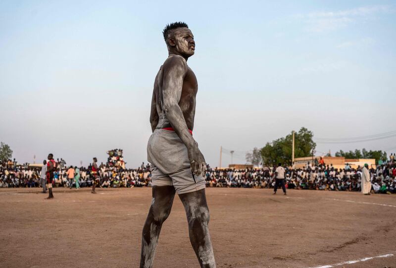 A wrestler stands by the ring during a traditional Nuba wrestling competition in Sudan's capital Khartoum.