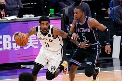 Brooklyn Nets guard Kyrie Irving, left, drives downcourt against Sacramento Kings guard De'Aaron Fox during the first half of an NBA basketball game in Sacramento, Calif., Monday, Feb. 15, 2021. (AP Photo/Rich Pedroncelli)