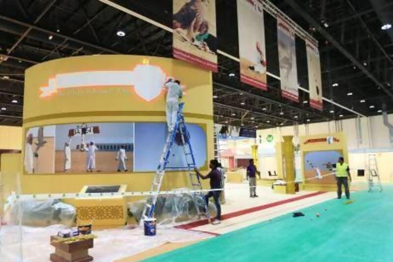 Stalls receive finishing touches for the opening of the Abu Dhabi International Hunting and Equestrian Exhibition today. Ravindranath K / The National