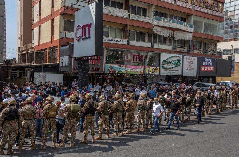 Lebanese army soldiers is surrounded the supporters of Lebanese Christians parties where they try to close the Northern Highway during a protest against the collapsing Lebanese pound currency and the price hikes of goods, in Al Zouk area, northern Beirut, Lebanon.  EPA