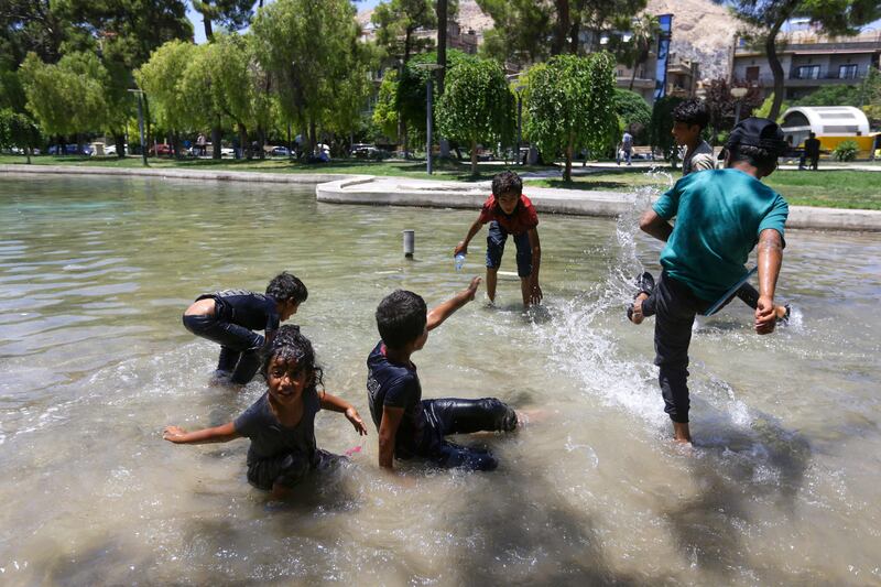 Youths play in a fountain at a park in the Syrian capital Damascus, as temperatures exceed 35°C. AFP