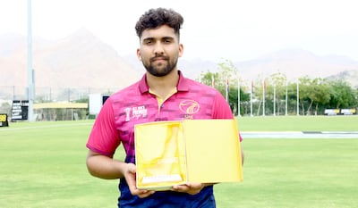 Alishan Sharafu of UAE with his player of the match award. Subas Humagain for The National