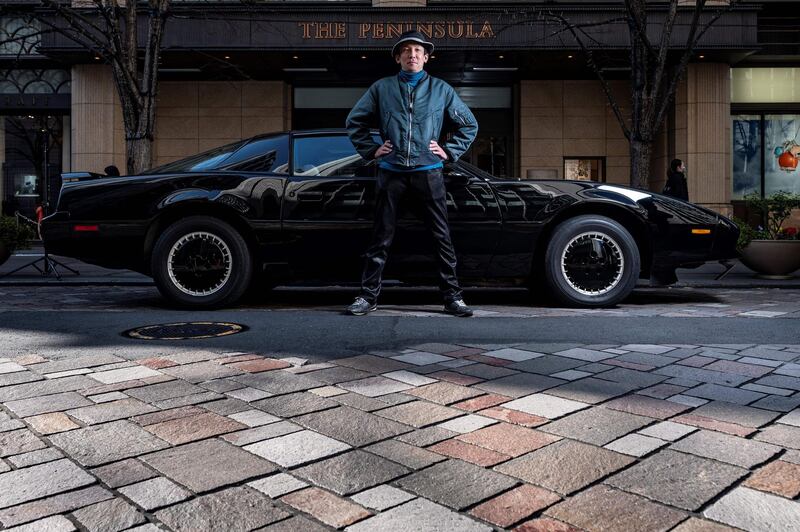 Masamune Isogai posing for a photo in front of a 1991 Trans Am Knight Rider during a gathering of auto enthusiasts in Tokyo. AFP