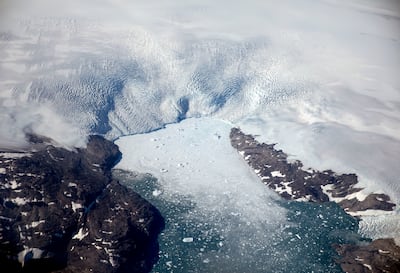 A glacier calves icebergs into a fjord off the Greenland ice sheet. AP Photo / David Goldman