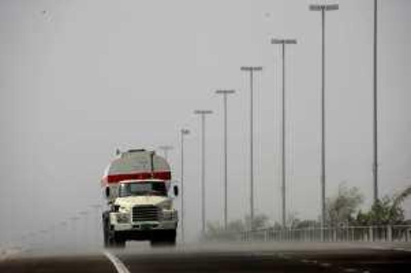 Abu Dhabi - June 15th  ,  2008 -Standalone picture of a lorry driving through a sand storm on the way to Midinat Zayed, Abu Dhabi    ( Andrew Parsons  /  The National ) *** Local Caption ***  ap004-1506-standalone.jpgap004-1506-standalone.jpg