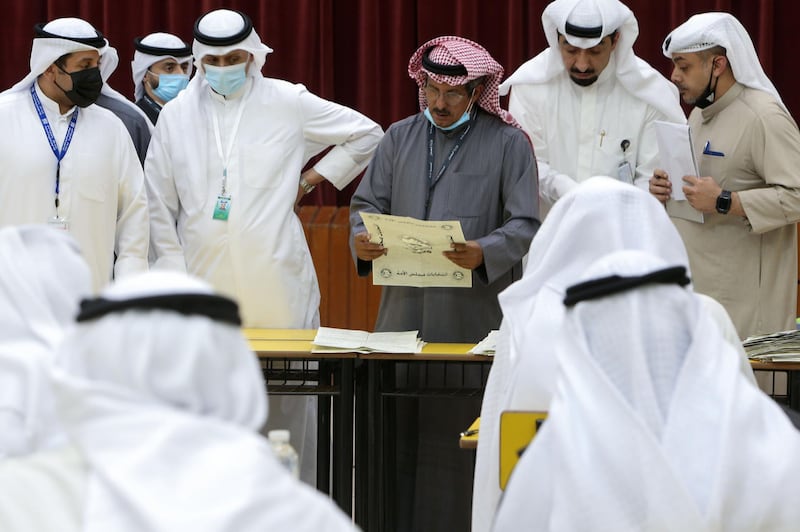 A Kuwaiti judge and his aides count the ballots at a polling station at the end of the parliamentary elections vote, in the Abdullah al-Salem district of Kuwait city. AFP
