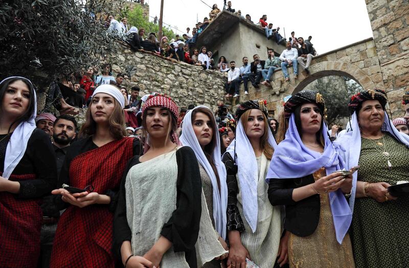 Iraqi Yazidi women gather outside the Temple of Lalish, in a valley near the Kurdish city of Dohuk about 430 kilometres northwest of the capital Baghdad, on April 16, 2019. AFP