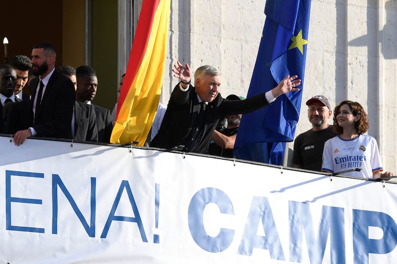 Real Madrid manager Carlo Ancelotti waves from the regional government headquarters in Madrid. AFP