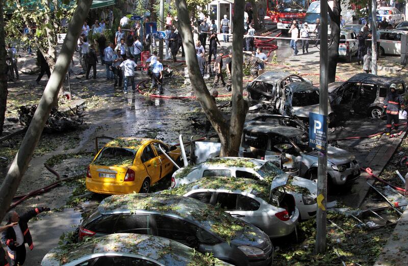 Burnt and damaged cars are seen at the site after a car bomb exploded in a busy street in the Turkish capital Ankara, Turkey, Tuesday, Sept. 20, 2011. A car bomb went off near a high school in the Turkish capital on Tuesday, killing three people in a nearby building and wounding 34 others, authorities said. The prosecutor's office said the blast was a terrorist attack. (AP Photo) *** Local Caption ***  Turkey Explosion.JPEG-04701.jpg