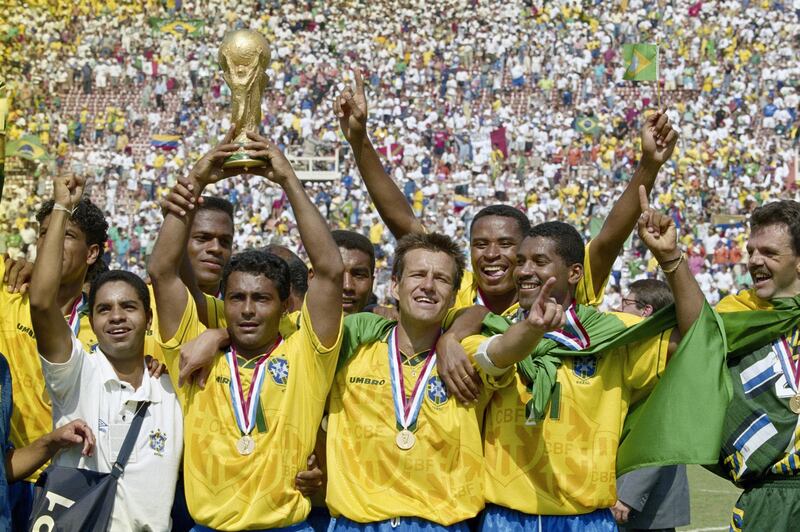 Romario (with trophy) and captain Dunga of Brazil and the Brazilian team celebrate after winning the1994 FIFA World Cup Final against Italy on 17 July 1994 played at the Rose Bowl in Pasadena, California, United States. Brazil defeated Italy 3-2 in a penalty shootout.(Photo by Ben Radford/Getty Images) 