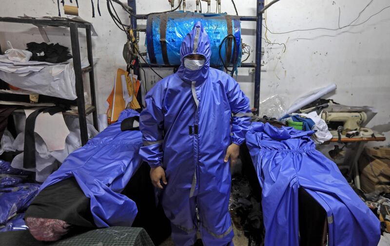 Palestinian workers manufacture protective coverall suits and maks at a workshop in Gaza City amid the coronavirus pandemic.  AFP