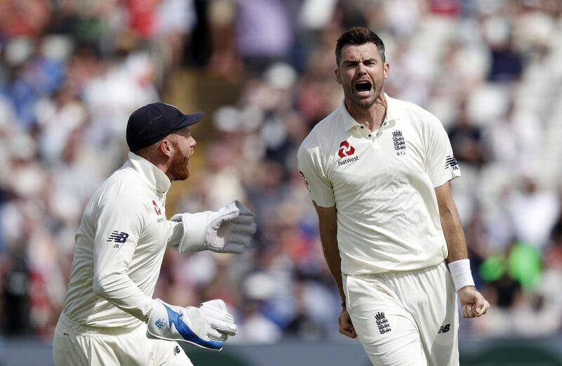 England's bowler James Anderson (R) celebrates with England's Jonny Bairstow (L) after taking the wicket of India's Dinesh Karthik during play on the fourth day of the first Test cricket match between England and India at Edgbaston in Birmingham, central England on August 4, 2018. / AFP PHOTO / ADRIAN DENNIS