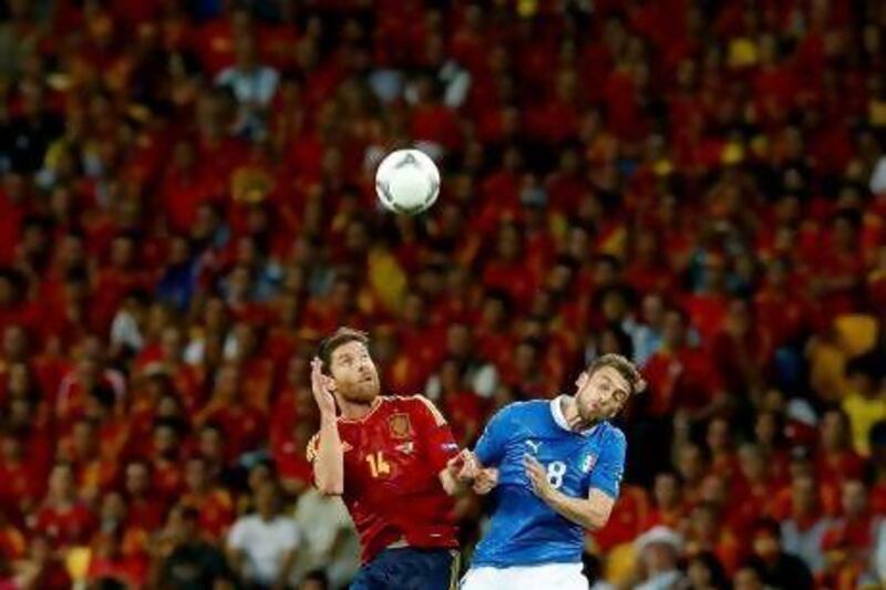 Spain's Xabi Alonso, left, and Italy's Claudio Marchisio go for a header. KERIM OKTEN / EPA