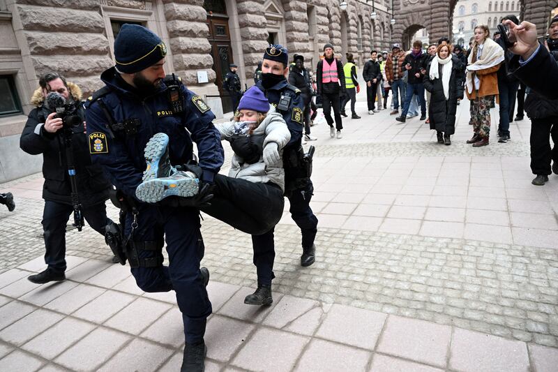 Greta Thunberg is removed by police officers during a demonstration outside the Swedish parliament building, in Stockholm. Reuters