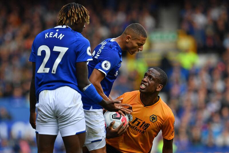 Wolverhampton Wanderers' French defender Willy Boly clashes with Everton's Italian striker Moise Kean. AFP