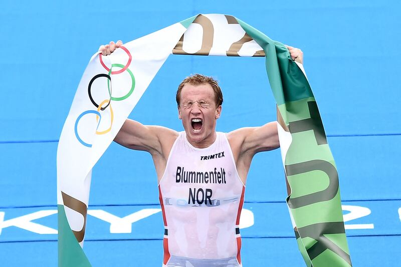 Norway's Kristian Blummenfelt celebrates finishing first to win gold.