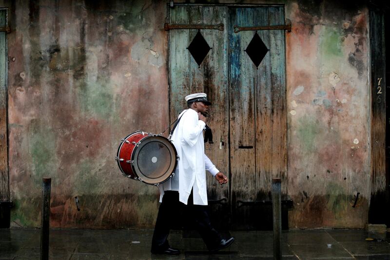 A musician walks in the French Quarter as Hurricane Nate approaches the US Gulf Coast in New Orleans, Louisiana. Jonathan Bachman / Reuters