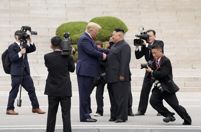 FILE PHOTO: File picture of U.S. President Donald Trump meeting North Korean leader Kim Jong Un at the demilitarized zone separating the two Koreas, in Panmunjom, South Korea, June 30, 2019. REUTERS/Kevin Lamarque/File Photo
